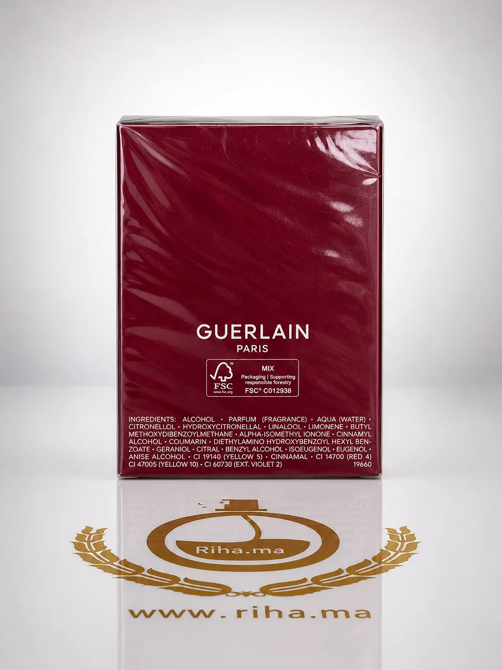 habit rouge de guelain paris parfum 100ml — photo 2 Flacon de habit rouge de guelain parfum posé sur fond rouge élégant — vue 2